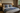 Bedroom with a bed featuring blue and white patterned pillows and blanket.