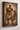 Afro-modern framed stretched canvas artwork of a traditional African warrior holding a spear and shield, displayed at a slight angle on a textured warm neutral wall, showcasing canvas depth, rich earthy tones, and soft natural shadows.