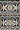 Ndebele pattern geometric wallpaper with with various geometric shapes in a repeating order. Colours brown, beige, black and white