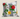 Tsonga Floral botanical cushion with red, yellow, pink and blue flowers on grey and white vertical stripes against a neutral background.