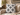 White Basotho-inspired geometric cushion styled on a textured neutral armchair with warm Afro-modern décor.