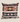 Top view of NIZARRA Sepedi-inspired geometric cushion showing the concealed black zip and patterned fabric detail.