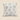 Cream rectangular mud cloth-inspired cushion with black hand-drawn linear marks, dotted patterns, and circular motifs on a warm neutral background.