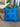 Blue pillow with circular pattern on a brown couch in a living room setting