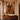 Afro-modern interior with large framed African artwork depicting a couple in warm earthy tones, styled above a wood console.