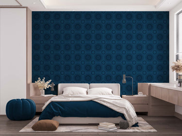 A bedroom with complete bedroom furniture and bedding. On the one wall is a wallpaper with a blue background and navy circles.