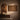 Contemporary African interior with portrait art and large patterned textile wall hanging, styled with wooden furniture and ceramic decor in warm neutral tones.