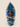 Side profile of the blue, black and grey Zulu bead-inspired NIZARRA cushion showing its seam, zip and patterned fabric.