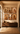 Sankofa Collection by NIZARRA, Afro-modern African wall art gallery featuring six framed artworks above a wooden console in a warm neutral interior with natural textures