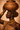 Close-up detail of The Bearer – Sankofa I by NIZARRA, highlighting clay vessel texture, gold jewelry, and rich earthy tones”