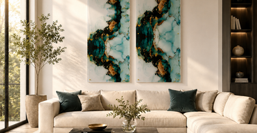 Modern luxury living room featuring two NIZARRA teal, black and gold acrylic wall art panels above a cream sectional sofa.