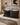 Decorative pillows with black and white patterns on a bed in a bedroom setting.