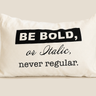 Front view of a white NIZARRA cushion with the message “Be Bold, or Italic, never regular.” in black typography.