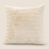 Cream faux fur cushion with soft horizontal channel detailing, shown on a warm neutral background for a clean product image.