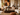 Smiling family of four relaxing together in a bright, cohesive Afro-modern NIZARRA living room with warm neutral furnishings, African-inspired artwork and natural textures.