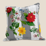 Tsonga Floral botanical cushion with red, yellow, pink and blue flowers on grey and white vertical stripes against a neutral background.
