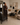 Thoughtful homeowner standing in a warm neutral living room that still feels unresolved despite its carefully chosen furniture and décor.