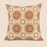 Front view of a cream rectangular cushion with rust-brown Setswana-inspired concentric circle and dotted motif pattern on a warm neutral background.