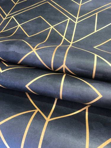 Close-up of Midnight Gold Art Deco wallpaper rolls showing a textured midnight  black surface and metallic gold geometric lines, highlighting the wallpaper's colour and finish.