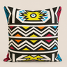 Front view of the NIZARRA Ndebele-inspired cushion featuring bold black-and-white zigzags with yellow, blue, orange and pink accents.