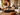 Family relaxing in a warm Afro-modern living room with neutral seating, African-inspired artwork, layered cushions, natural textures and refined styling after a NIZARRA One-Day Room Reset.