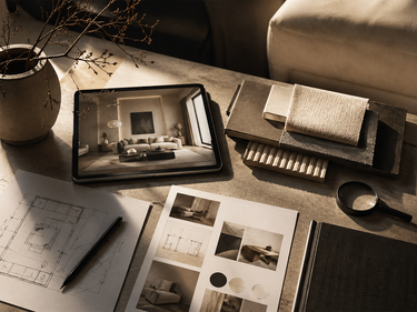 Afro-modern interior design workspace featuring material samples, architectural sketches, and a digital room concept displayed on a tablet. Warm neutral textures, sculptural styling, and layered finishes reflect the NIZARRA Space Audit process and spatial design direction.