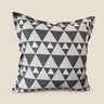 Grey and white geometric triangle Xhosa inspired NIZARRA cushion on a warm neutral background, shown from the front for a clean product catalogue image.