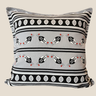 Grey, black and white Swazi-inspired cushion with horizontal stripes, leaf motifs and small red accents on a plain neutral background.