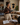 Woman holding a tablet in a warm NIZARRA Afro-modern living room while reviewing design plans for a cohesive, attractive and functional rental property.