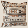 Front view of a square Sepedi-inspired cushion with cream, rust, dark brown and white geometric stripe patterns.