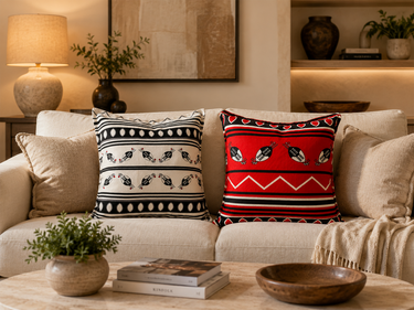 Decorative pillows on a sofa with a coffee table in a living room setting.