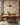 NIZARRA Terra Rhythm mud cloth-inspired geometric wallpaper in an industrial dining nook with cognac leather seating, black metal chairs and a rustic wooden table.