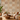 NIZARRA Terra Rhythm wallpaper on a contemporary living room feature wall, featuring clay, rust and grey geometric motifs with a cream sectional sofa and wooden coffee table.