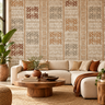 NIZARRA Terra Rhythm wallpaper on a contemporary living room feature wall, featuring clay, rust and grey geometric motifs with a cream sectional sofa and wooden coffee table.