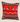Front view of a red, black and white Swazi-inspired cushion with shield motifs, stripe detailing and a bold white zigzag pattern on a neutral background.