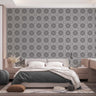 A bedroom with complete bedroom furniture and bedding. On the one wall is a wallpaper with a light grey background and dark grey circles.