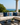 NIZARRA Venda-inspired geometric cushion styled with navy cushions on a cream outdoor sectional overlooking the ocean.