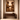 The Offering by NIZARRA, framed canvas African wall art in an Afro-modern interior above a wooden console table with warm plaster walls