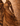 Close-up of flowing fabric texture and movement in The Passage Sankofa IV artwork, showing detailed folds and warm earth tones